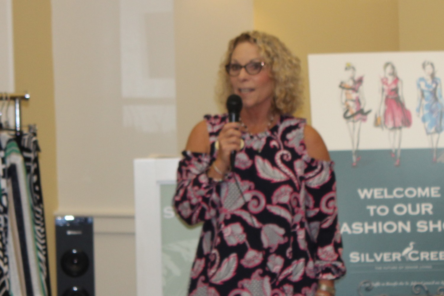 Silver Creek Community Outreach Coordinator Ilene Thrasher addresses those in attendance at the fashion show.